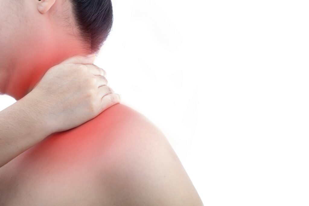 Young woman with neck pain and at white background